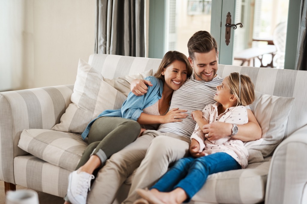 Family Sitting Happily In Sofa