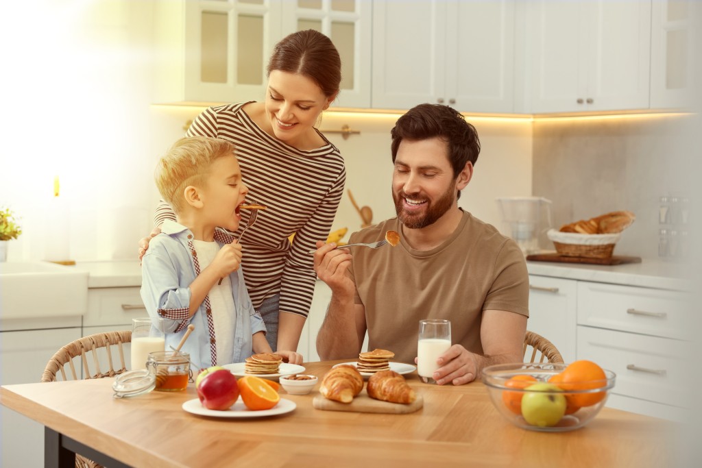 Son with father and mother enjoying food