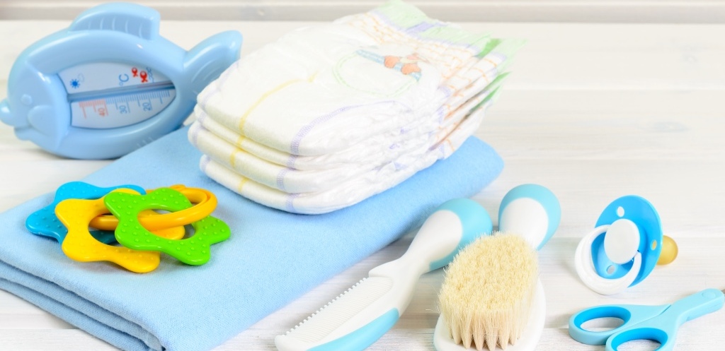 Baby accessories on white wood background