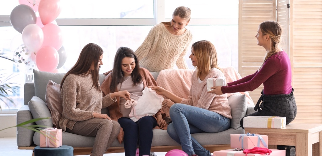 Pregnant woman with her friends at baby shower party