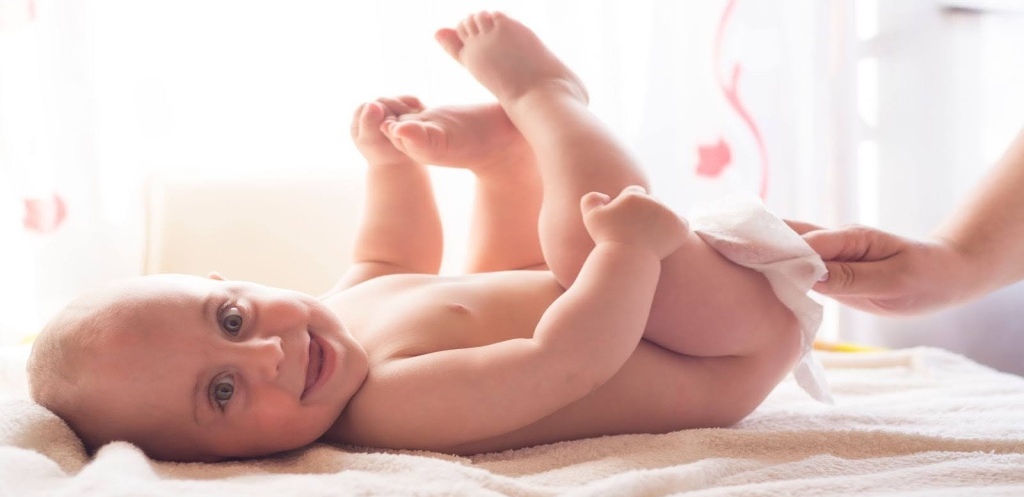 Mother changing diaper of baby